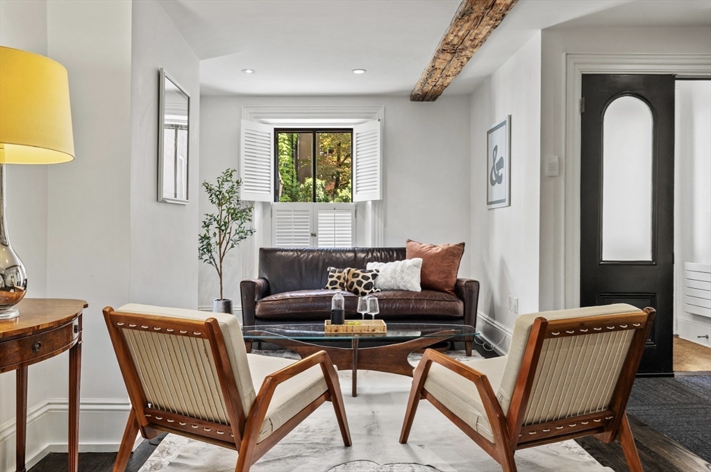 22 Joy Street Boston, MA 02114 - Photo 10 of 36 a living room with a couch and a potted plant