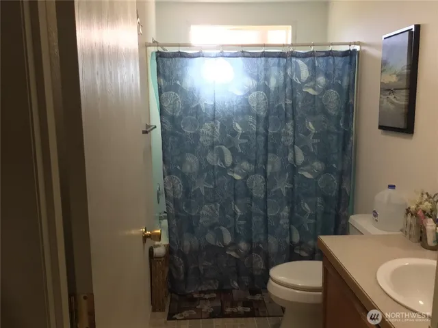 a bathroom with a shower and a toilet