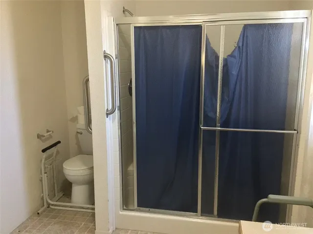a view of bathroom with shower and toilet