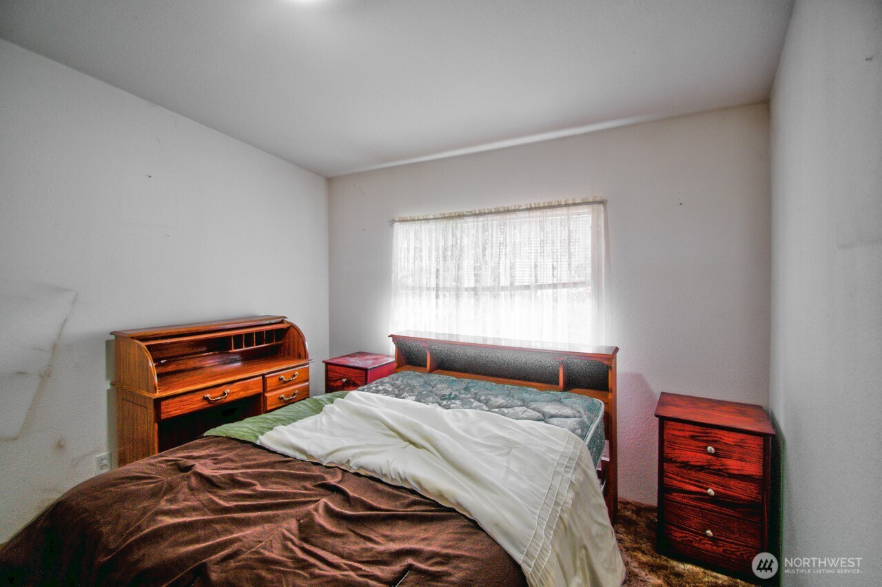 236 Tryon Road Onalaska, WA 98570 - Photo 12 of 40 a bedroom with a bed a closet and a window