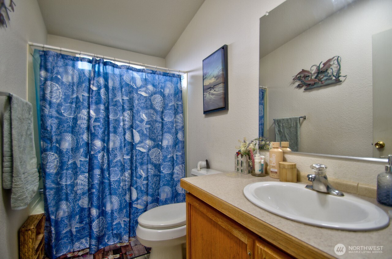 236 Tryon Road Onalaska, WA 98570 - Photo 13 of 40 a bathroom with a granite countertop sink and a mirror