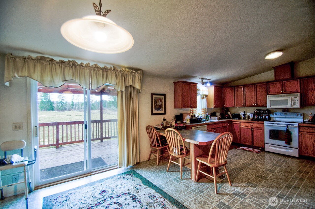 236 Tryon Road Onalaska, WA 98570 - Photo 14 of 40 a view of a dining room with furniture window and wooden floor