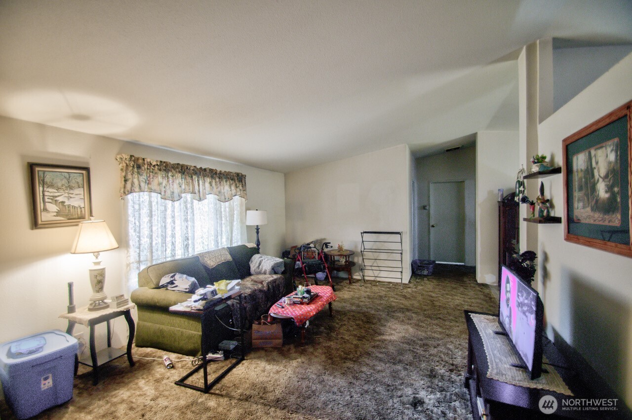 236 Tryon Road Onalaska, WA 98570 - Photo 17 of 40 a living room with furniture a window and a flat screen tv