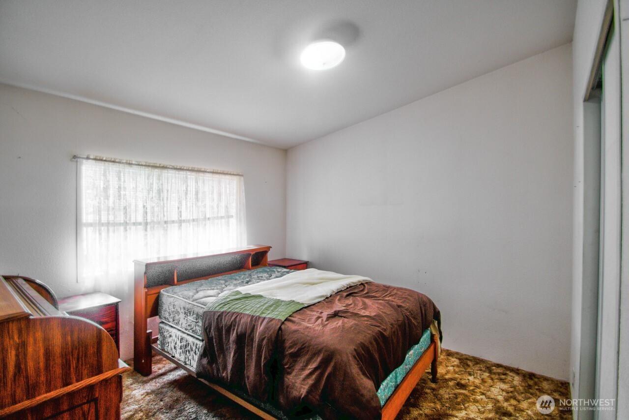 236 Tryon Road Onalaska, WA 98570 - Photo 21 of 40 a bedroom with a bed and window