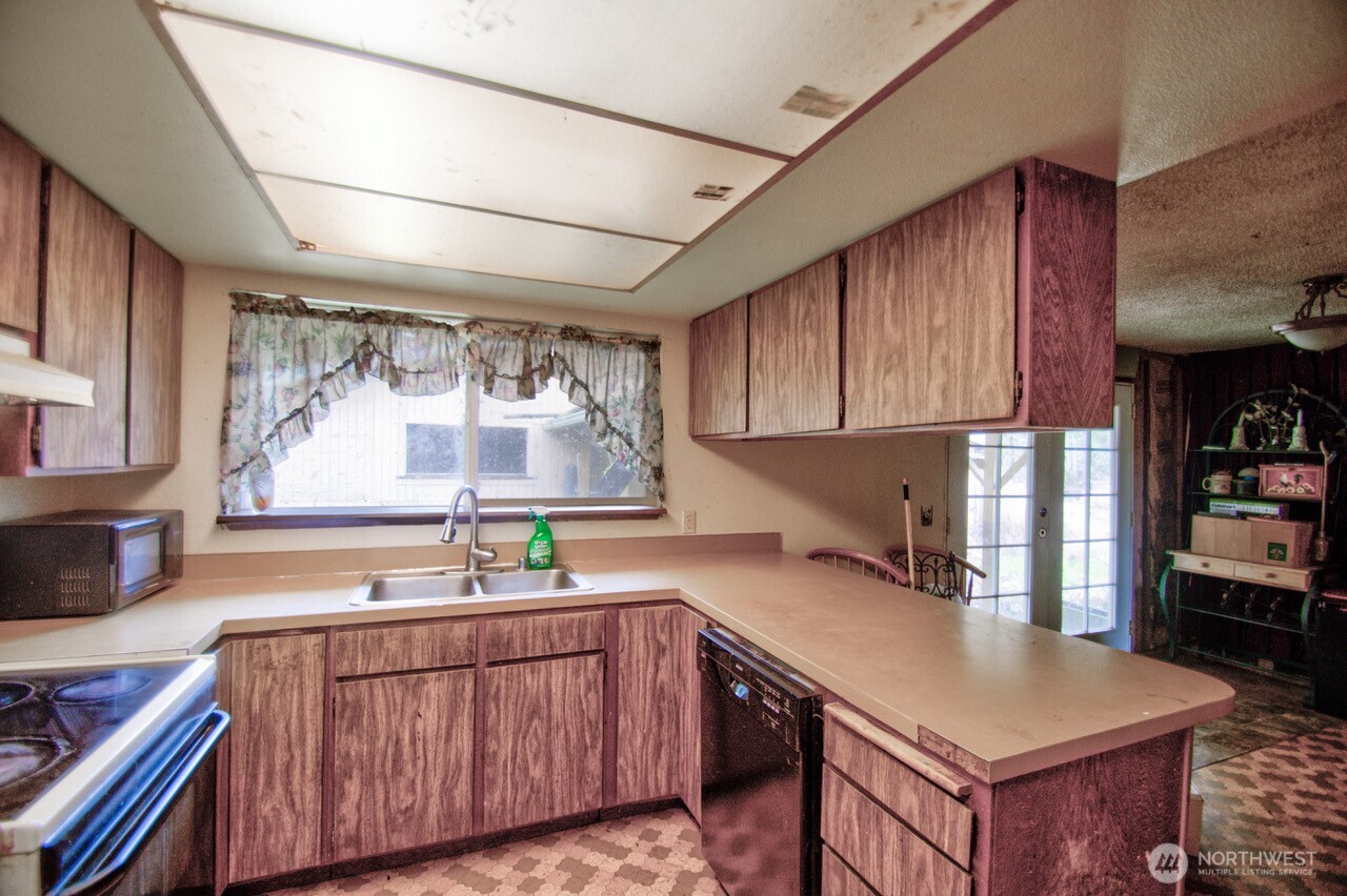 236 Tryon Road Onalaska, WA 98570 - Photo 27 of 40 a kitchen with a sink cabinets and window