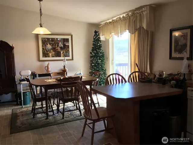 a dining room with furniture and window