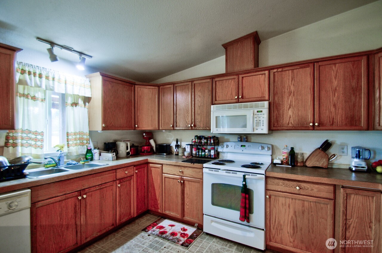 236 Tryon Road Onalaska, WA 98570 - Photo 7 of 40 a kitchen with a sink a stove and cabinets