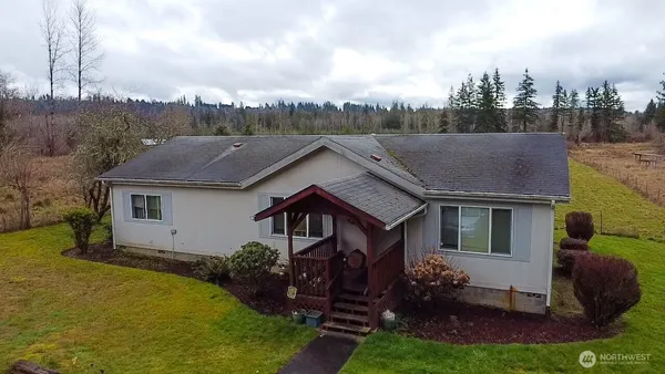 a aerial view of a house next to a yard