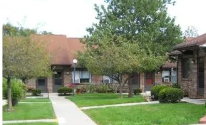 front view of a brick house with a yard