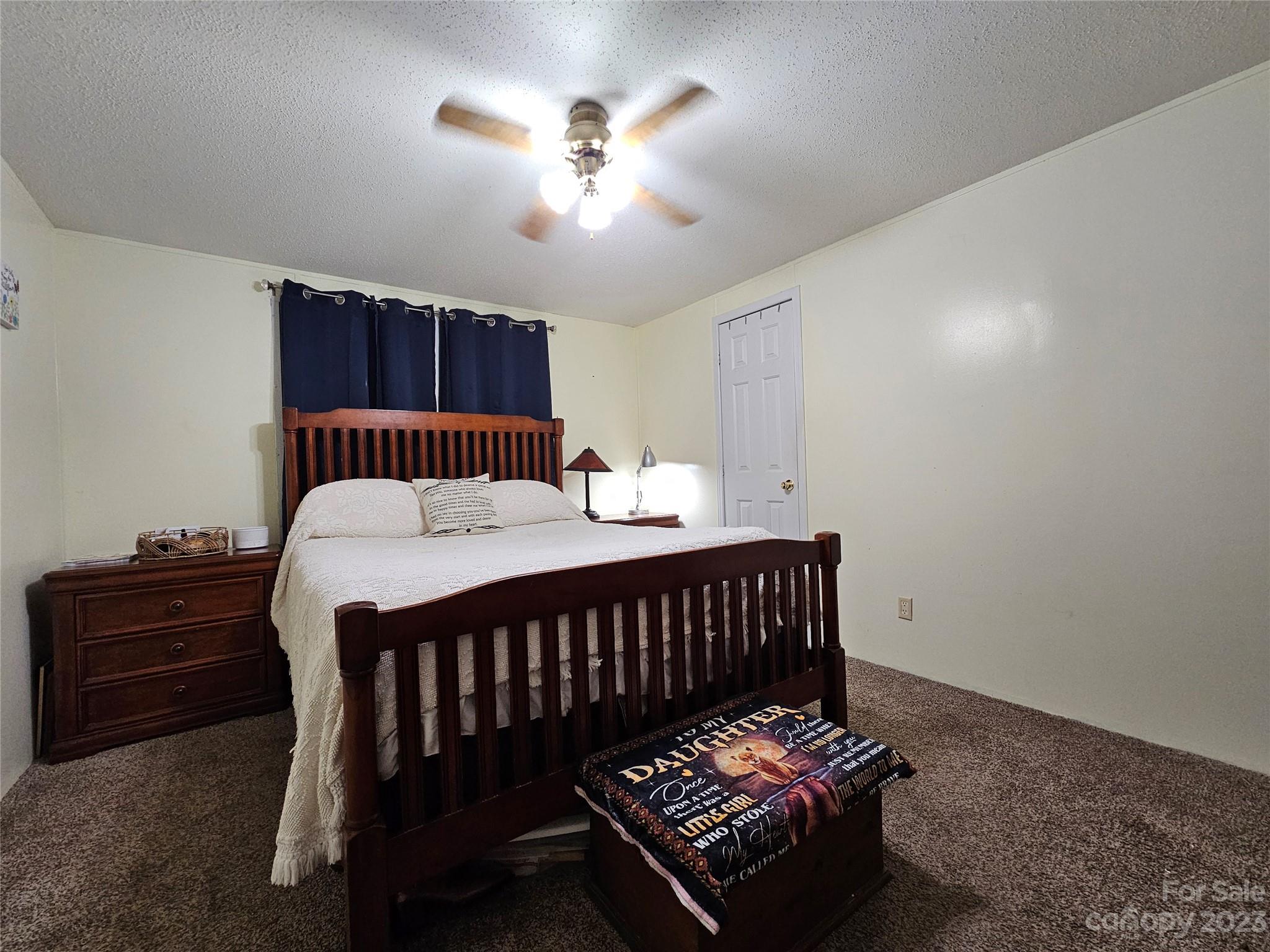 290 Long Street Rutherfordton, NC 28139 - Photo 17 of 23 a bedroom with a bed and a chandelier