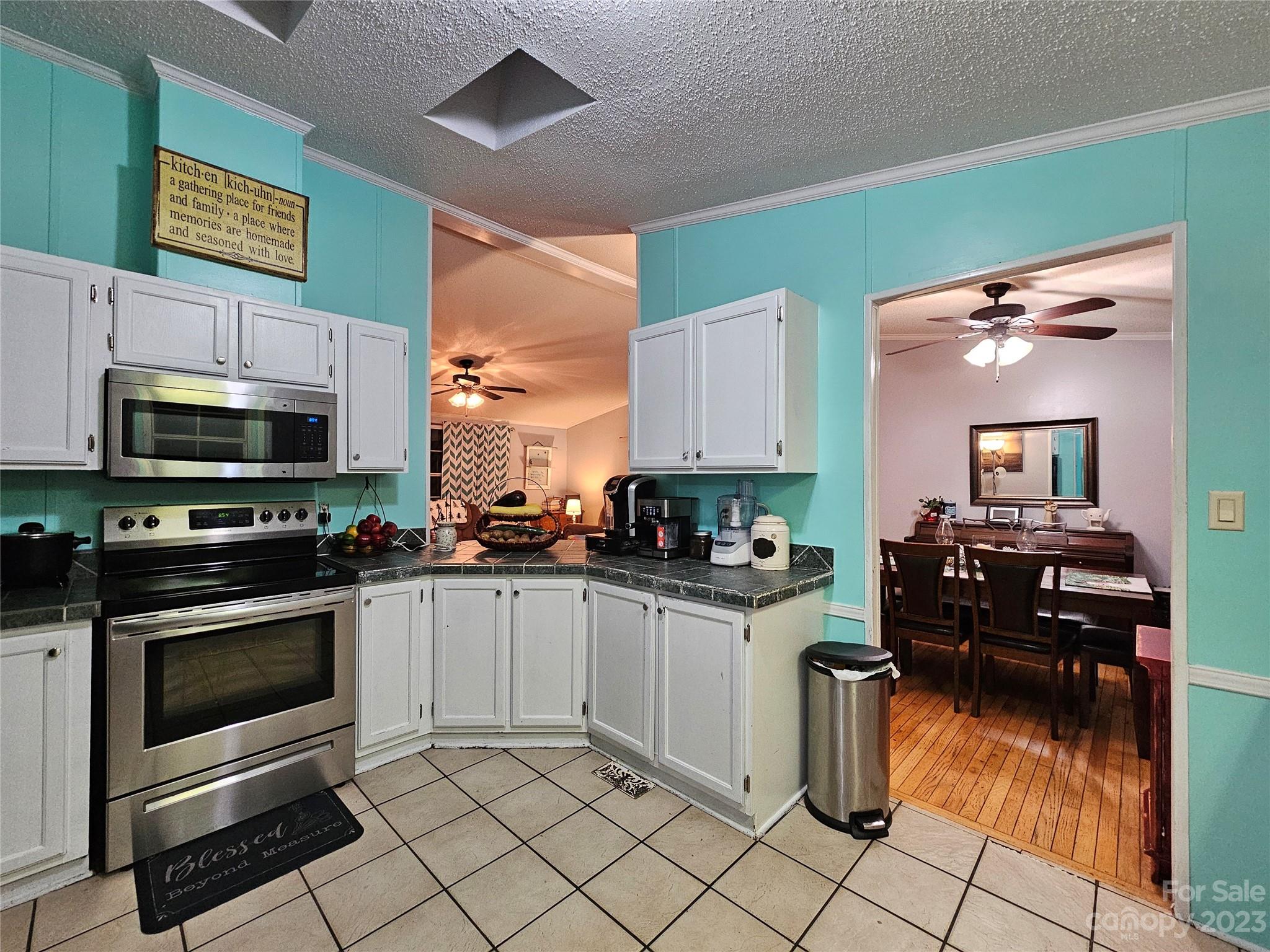 290 Long Street Rutherfordton, NC 28139 - Photo 8 of 23 a kitchen with stainless steel appliances kitchen island granite countertop a stove top oven and cabinets