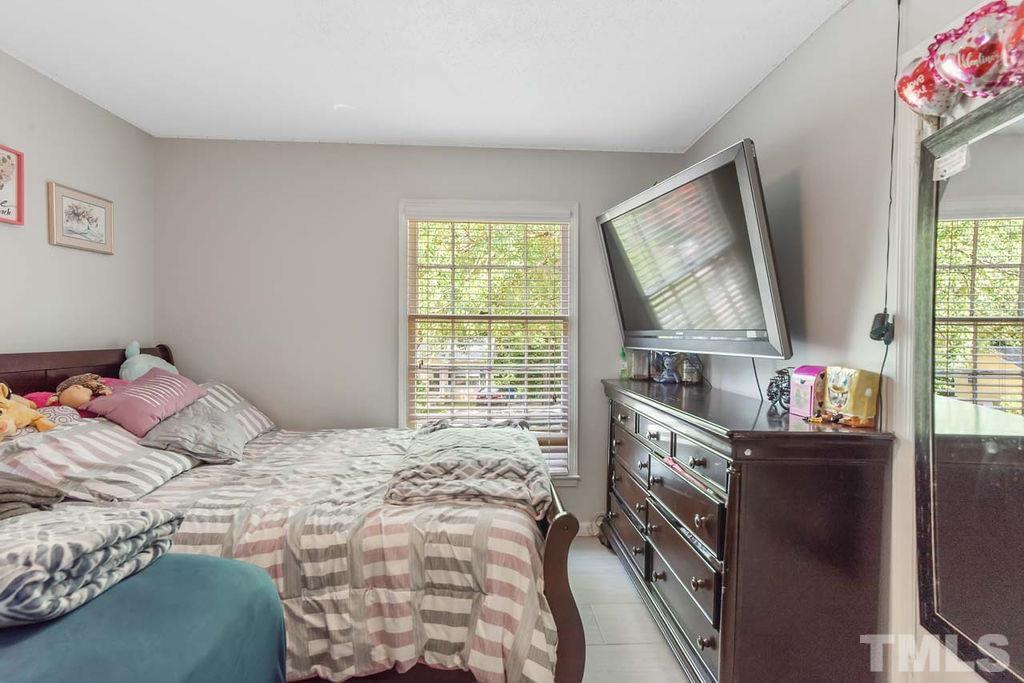 7500 Idolbrook Lane Raleigh, NC 27615 - Photo 20 of 28 a bedroom with a bed and a window