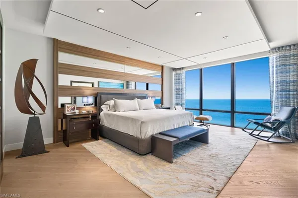 a bed room with a bed and a chair