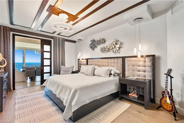 a bedroom with a bed a mirror and a desk