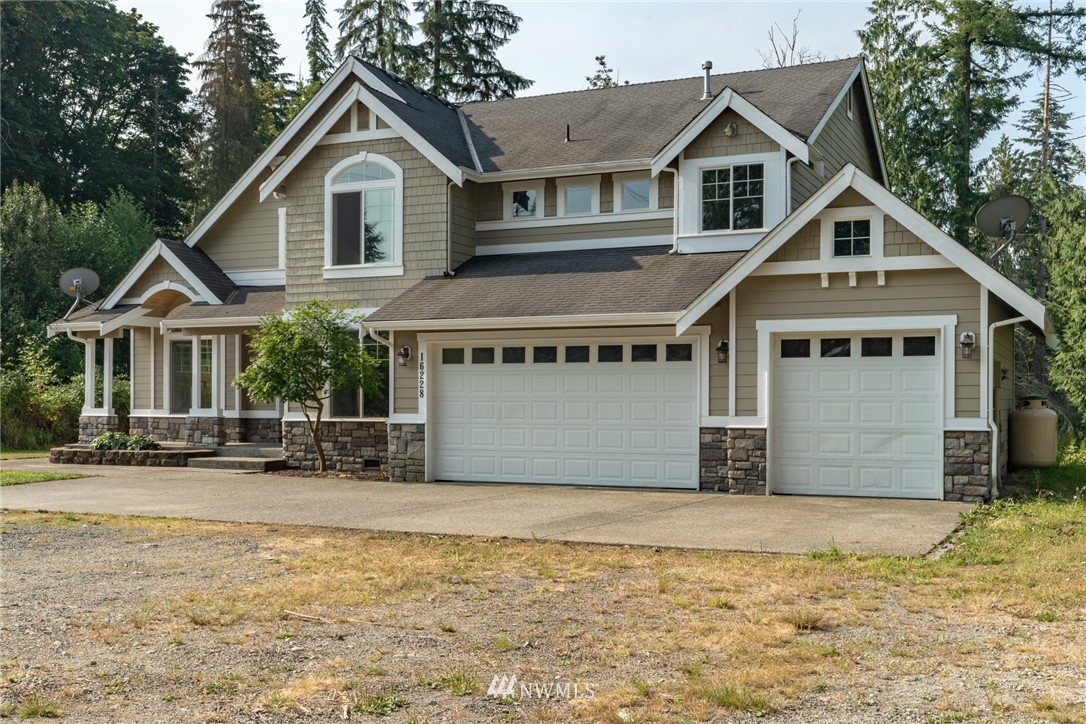 16228 Three Lakes Road Snohomish, WA 98290 - Photo 1 of 23 a front view of a house with a yard