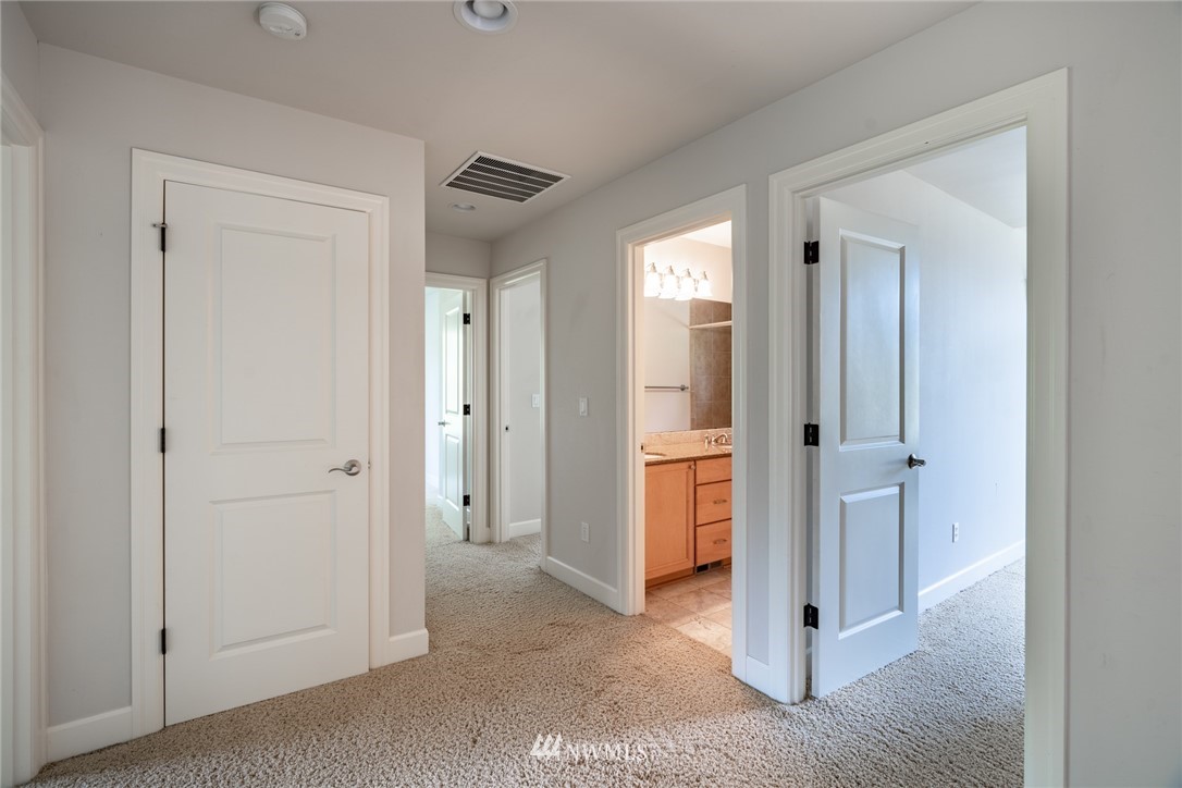 16228 Three Lakes Road Snohomish, WA 98290 - Photo 14 of 23 a view of a hallway with closet and bathroom
