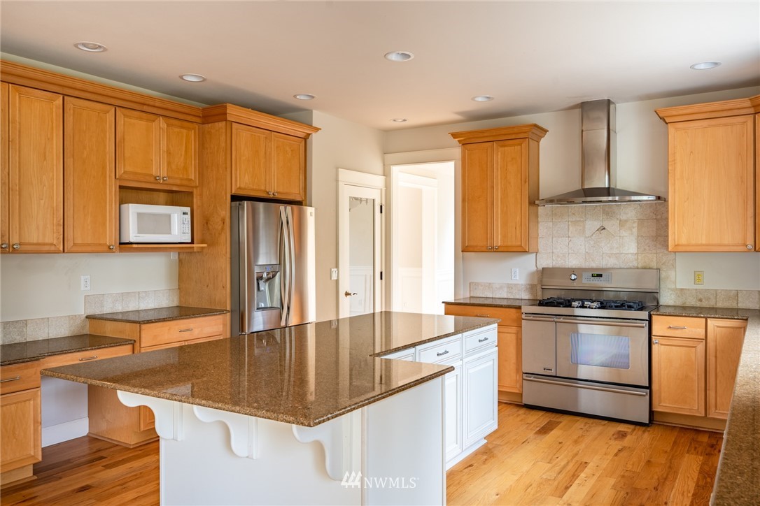 16228 Three Lakes Road Snohomish, WA 98290 - Photo 7 of 23 a kitchen with stainless steel appliances granite countertop a sink stove and refrigerator