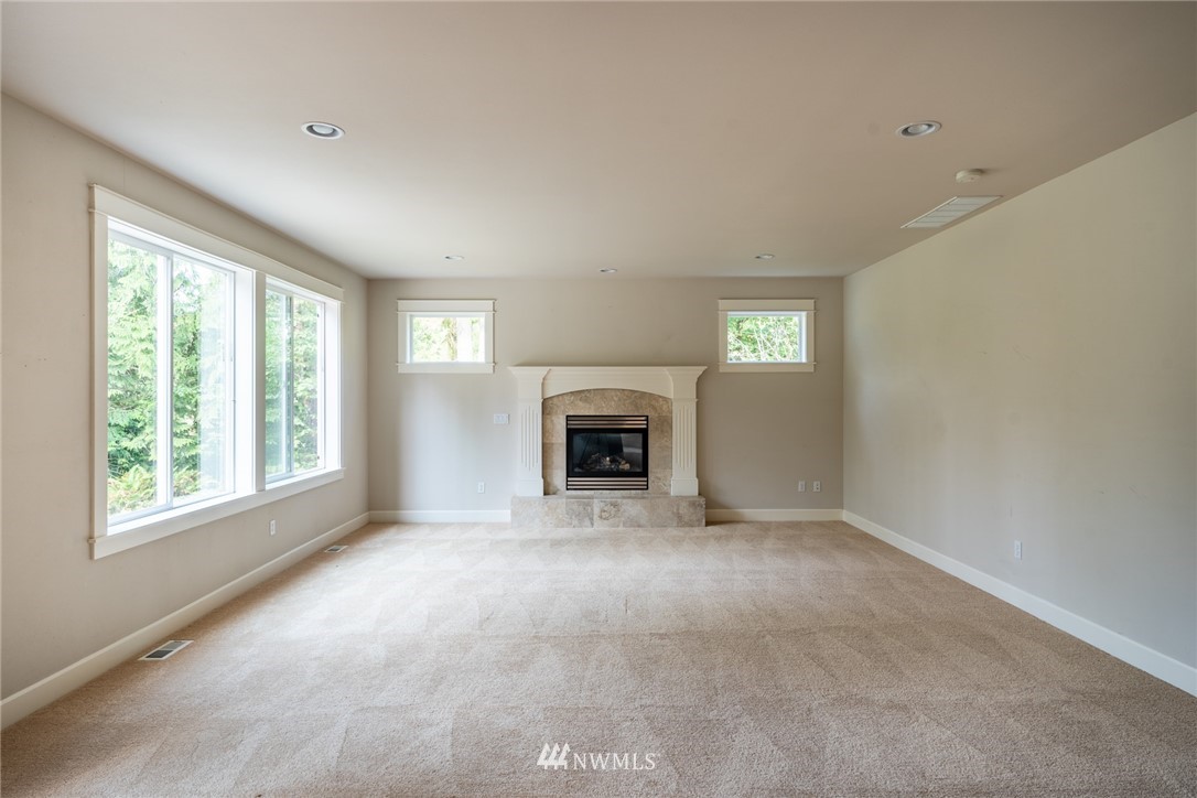 16228 Three Lakes Road Snohomish, WA 98290 - Photo 8 of 23 a view of empty room with a fireplace