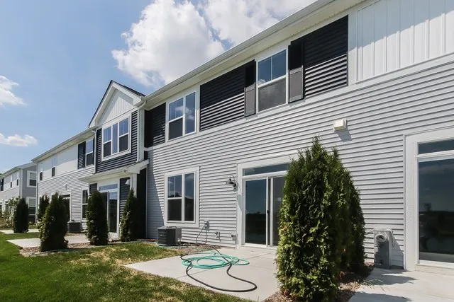 a view of a building with many windows and plants