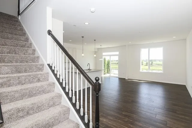 a view of an entryway with wooden floor