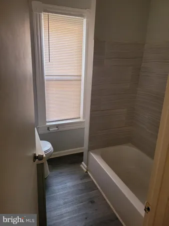 a bathroom with a bath tub and a window