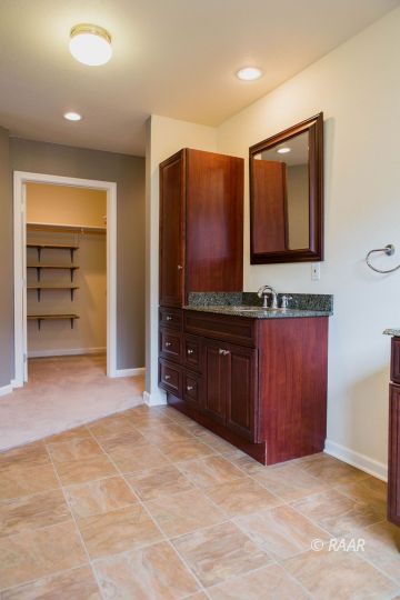 1633 South Farragut Street Ridgecrest, CA 93555 - Photo 26 of 30 a bathroom with a granite countertop sink and a mirror