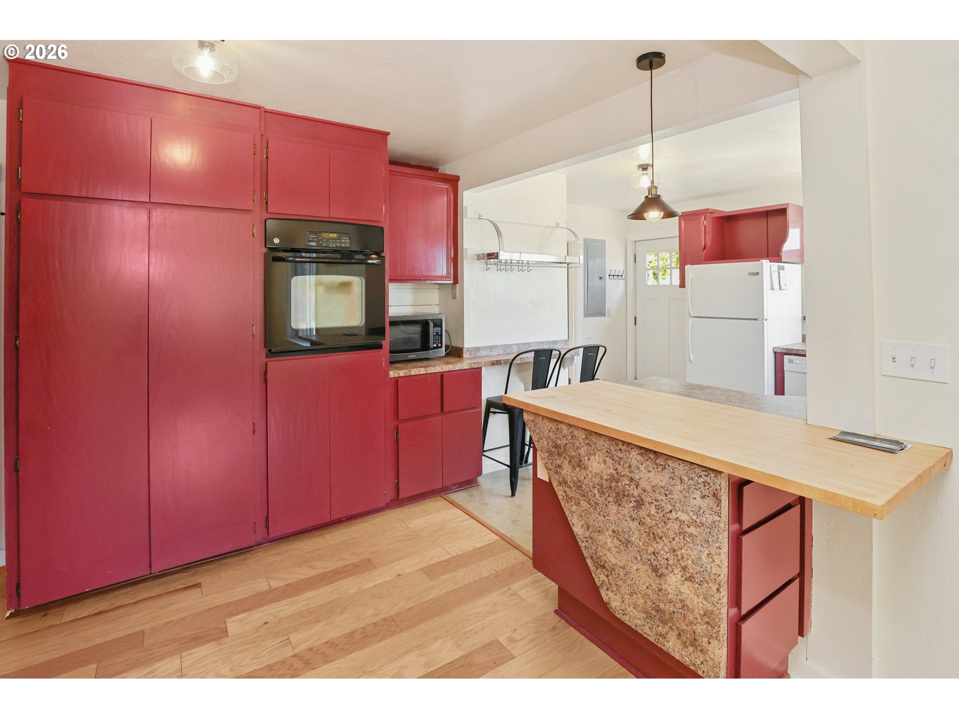 24496 McCain Road Monroe, OR 97456 - Photo 11 of 43 a kitchen with stainless steel appliances kitchen island granite countertop a table chairs in it and wooden floors