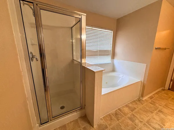 a bathroom with a shower and a tub