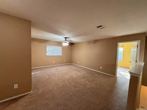 an empty room with a empty space and windows