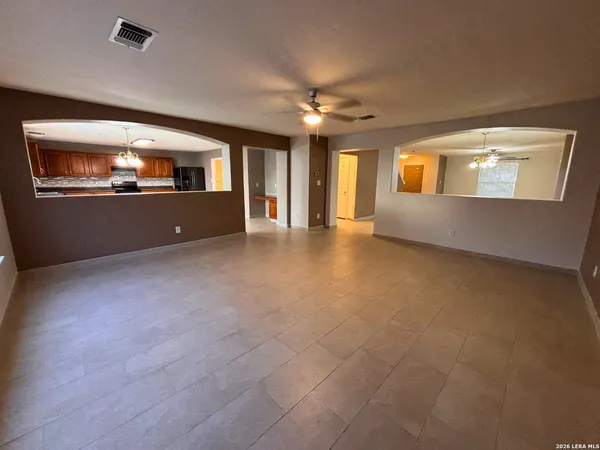 a view of a livingroom with a ceiling fan and window