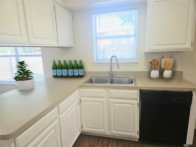 a kitchen with a sink cabinets and window