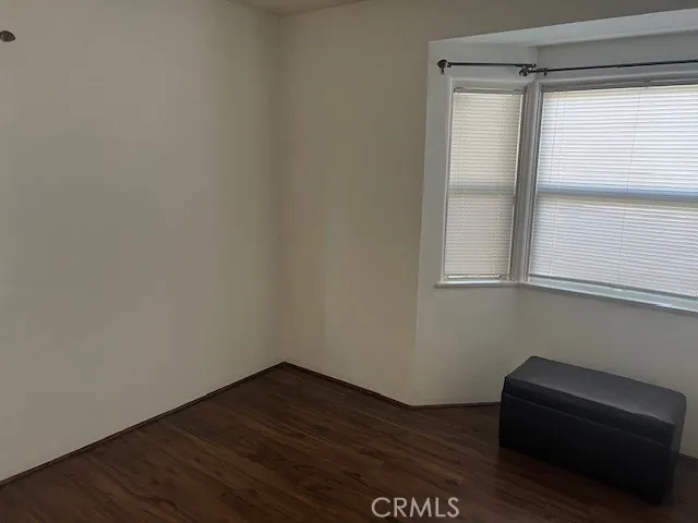 a view of a small space with wooden floor and a window