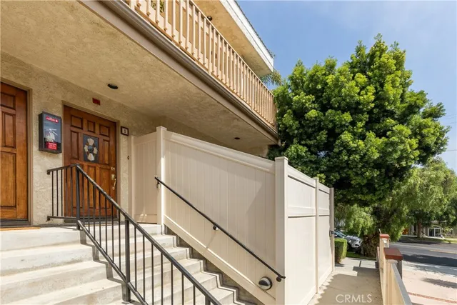 a living room with wooden floors and a fireplace