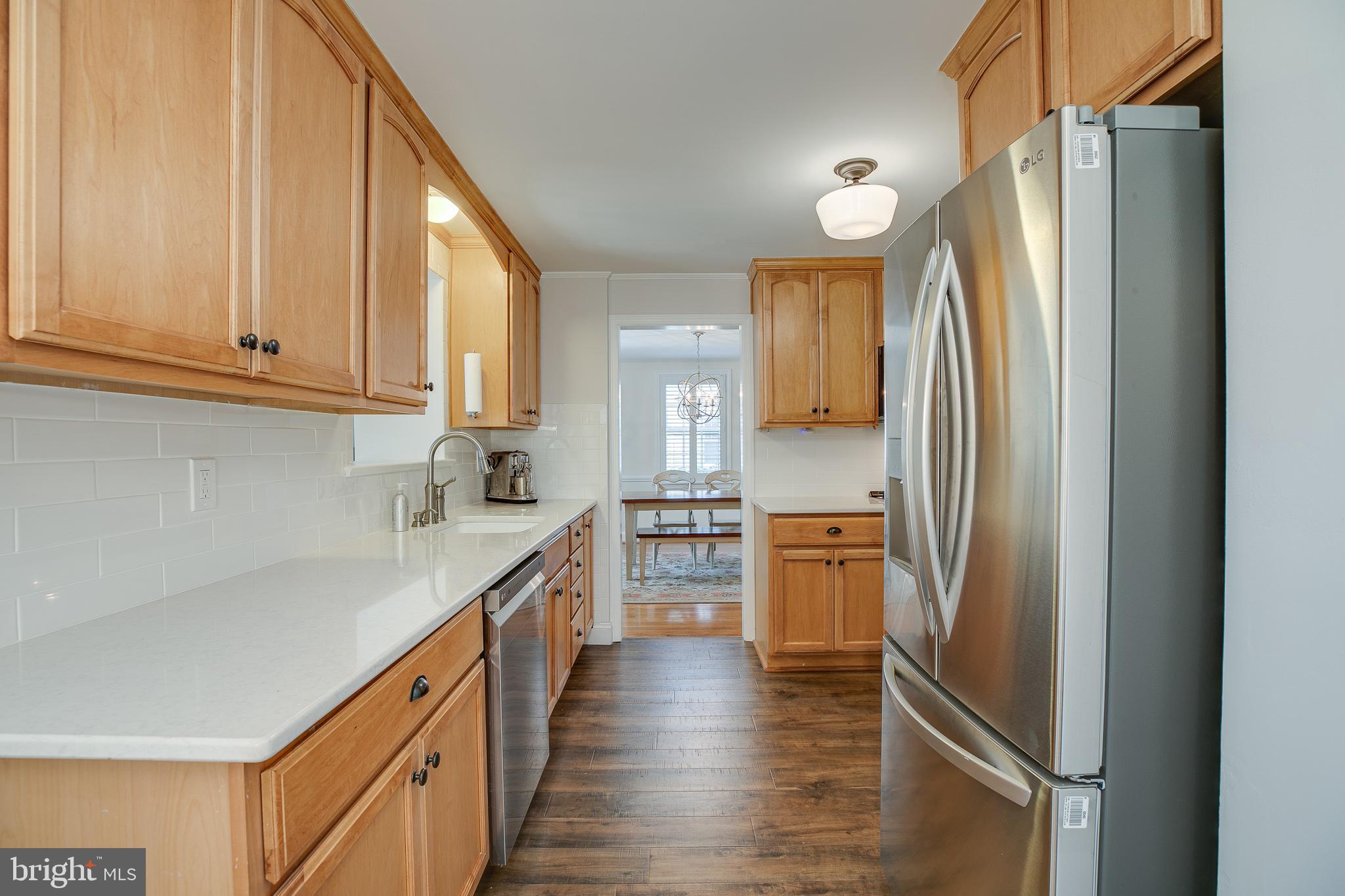 330 Old Lancaster Road Devon, PA 19333 - Photo 7 of 33 a kitchen with a refrigerator a sink and dishwasher a oven with wooden floor