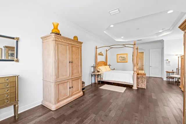 a bedroom with a bed mirror and a window