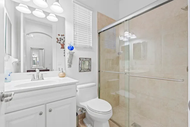 a bathroom with a double vanity sink mirror and toilet