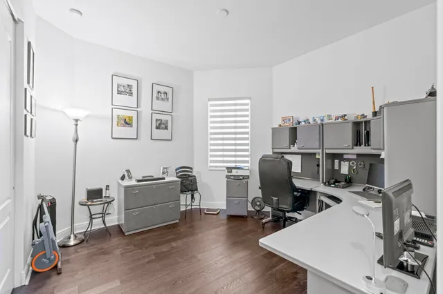 a view of a workspace with furniture and wooden floor