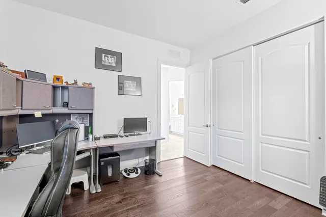 a view of a workspace with furniture and wooden floor