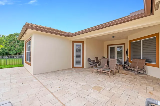 a view of a chairs and table in patio of a house