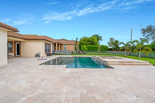 a view of a swimming pool with a yard