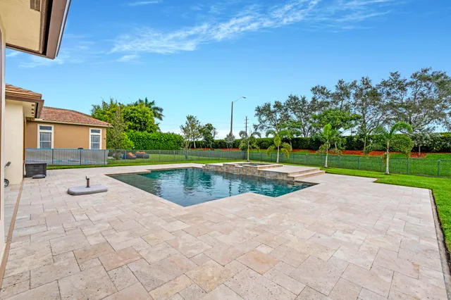 a view of a house with a yard and sitting area