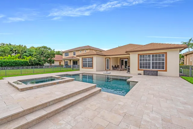 a front view of a house with yard and green space