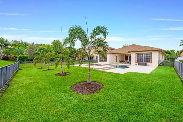 a view of a swimming pool with a yard