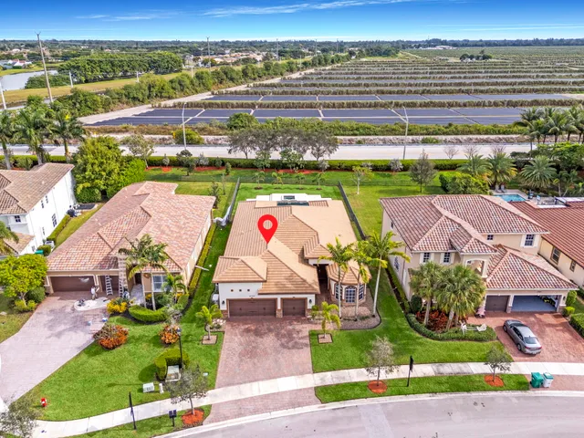 an aerial view of multiple houses with yard