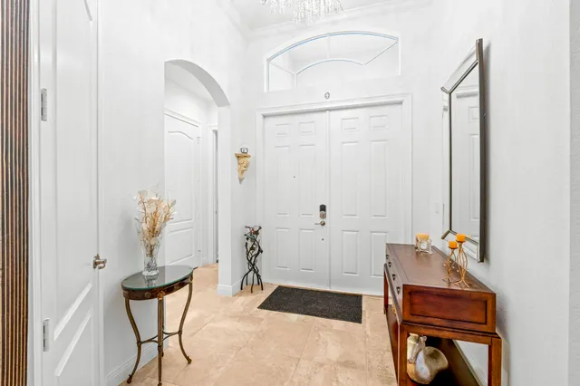 a living room with furniture a fireplace and a potted plant