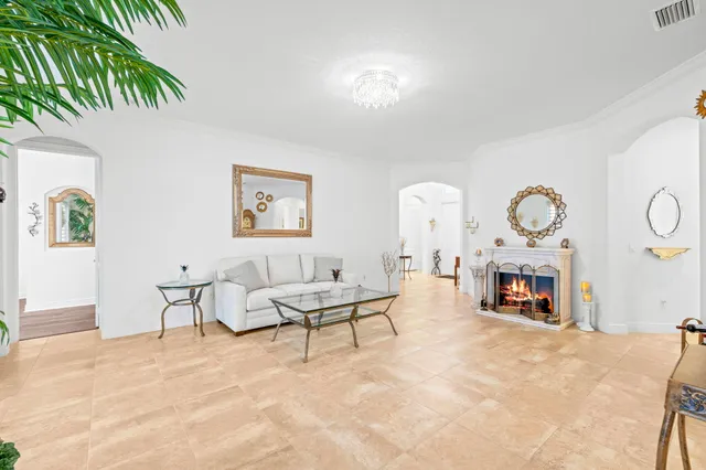 a living room with furniture a table and a potted plant