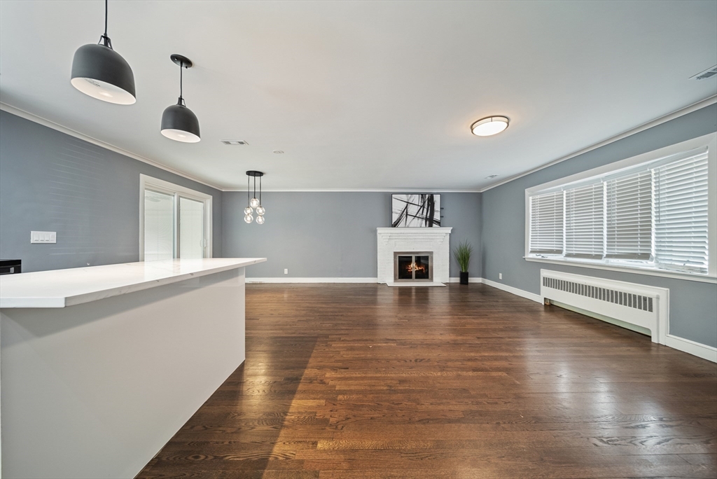 123 Walnut Street Saugus, MA 01906 - Photo 12 of 38 a view of an empty room with window and wooden floor