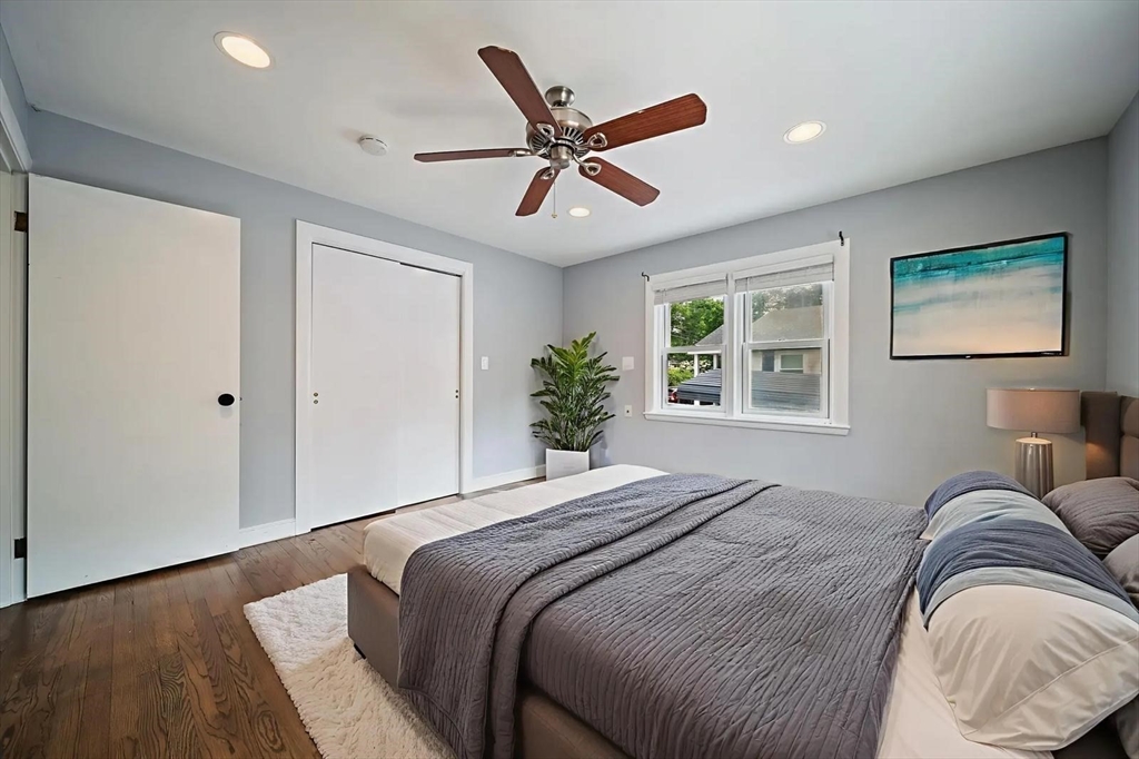 123 Walnut Street Saugus, MA 01906 - Photo 14 of 38 a bedroom with a large bed chandelier and a window