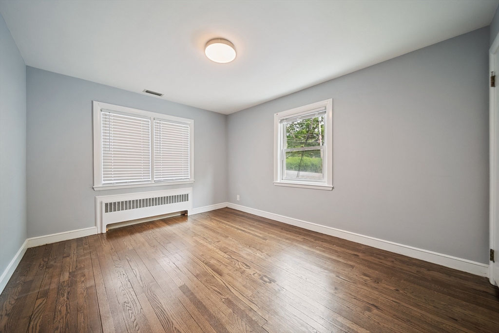 123 Walnut Street Saugus, MA 01906 - Photo 17 of 38 an empty room with wooden floor closet and windows
