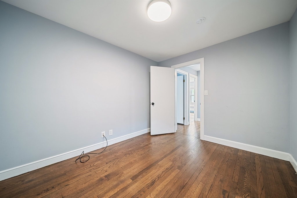 123 Walnut Street Saugus, MA 01906 - Photo 19 of 38 a view of an empty room with wooden floor